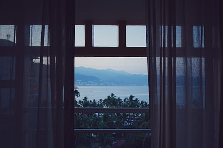 opened glass door overlooking beach thumbnail