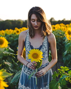 woman holding sunflower thumbnail