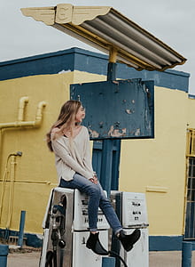 woman sitting on fuel dispenser thumbnail