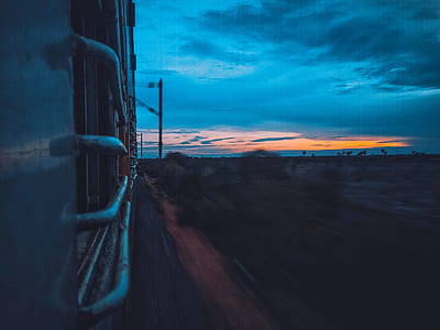 train under gray skies time lapse photography thumbnail