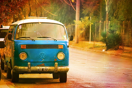 blue Volkswagen T2 parked on roadside beside empty road thumbnail