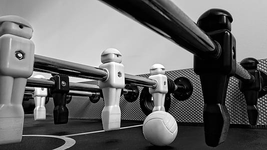 grayscale photo of foosball table thumbnail