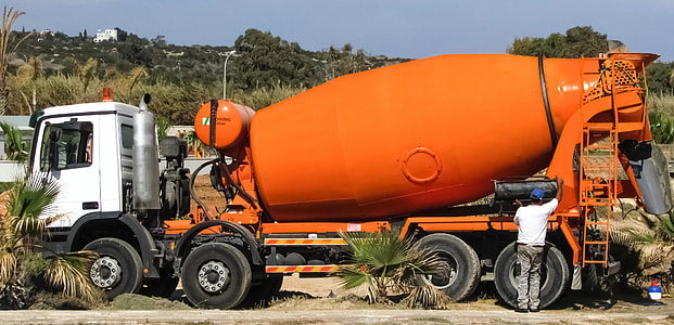 orange and white concrete mixer truck during daytime thumbnail