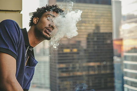smoking man near wall thumbnail