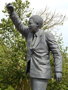 photo of gray concrete man raising his hand statue thumbnail