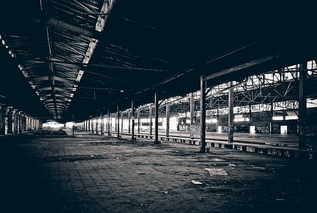 grayscale photography of railway beside station thumbnail