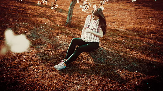 maternity photo shoot of woman wearing checked top and black leggings thumbnail