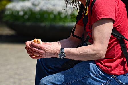 selective focus of man sitting holding hamburger thumbnail