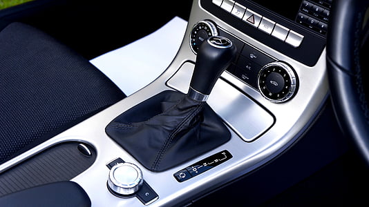 gray and black vehicle gear shift lever near center stack thumbnail