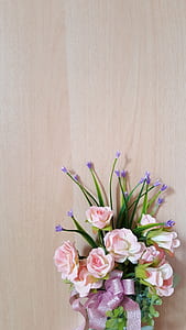 pink petaled flower on brown wooden surface thumbnail