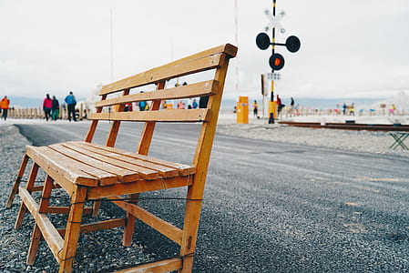 brown wooden bench placed on sidewalk thumbnail