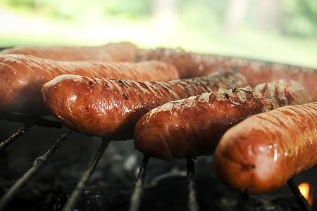 sausages grilled on black grill thumbnail