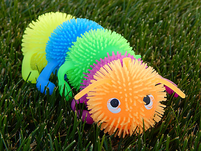 multicolored squeeze rubber caterpillar toy on grass thumbnail