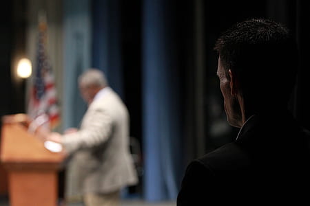 man standing in front of man thumbnail