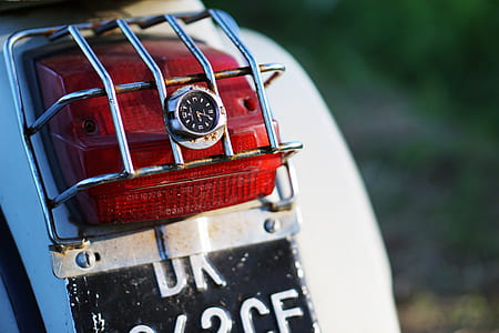 red motorcycle taillight on white fender thumbnail