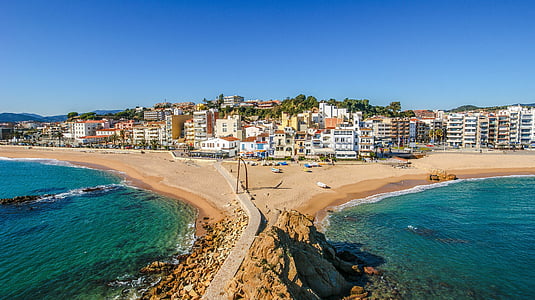 aerial photography of beach near buildings thumbnail