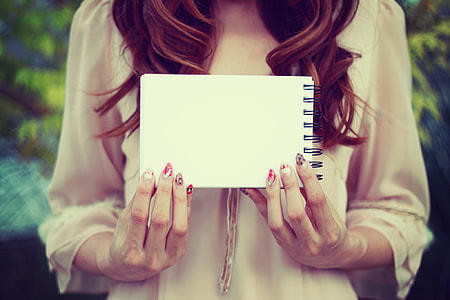 woman holding white notebook thumbnail