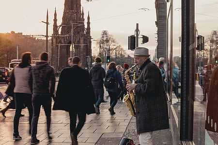 man standing while playing saxophone thumbnail