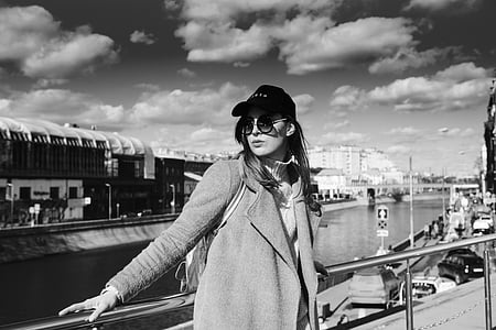 woman lying on steel fence during daytime thumbnail