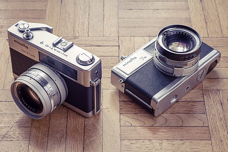 two black-and-silver Minolla cameras thumbnail