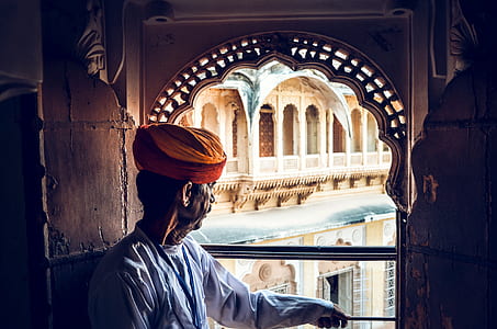 man looking out on window thumbnail