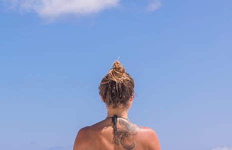 woman standing under blue sky thumbnail