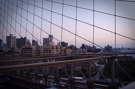 gray bridge near building during daytime thumbnail