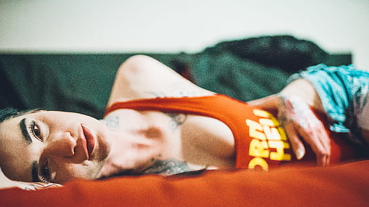 woman leaning on bed indoor thumbnail