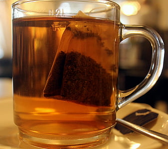 clear glass mug filled with tea thumbnail