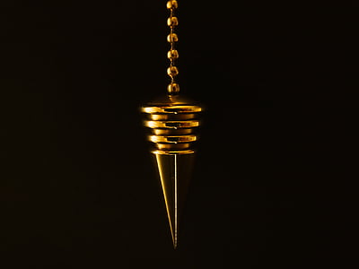 macro photography of gold pendant thumbnail