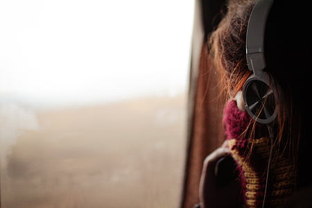 shallow focus photography of woman with headphones thumbnail
