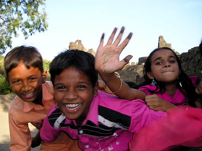 three children's standing near tree thumbnail