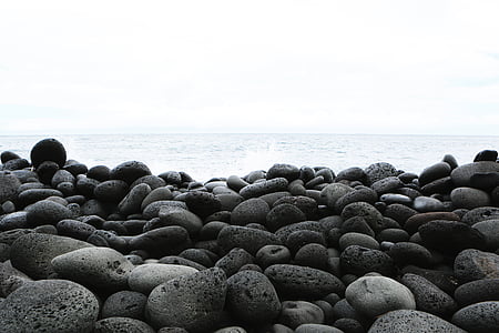 gray shore rocks near body of water at daytime thumbnail