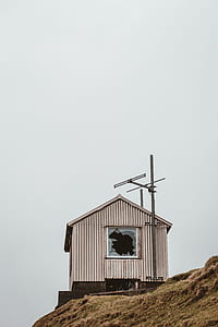 gray shed on the cliff at daytime thumbnail