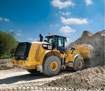 yellow CAT 965M front end loader in front of rocks thumbnail