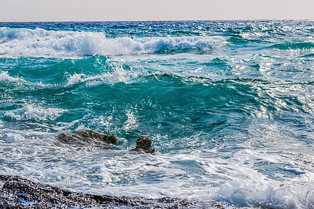 water waves hitting rock formation thumbnail