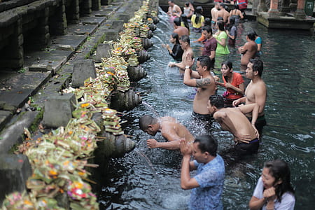 group of people bathing on body of water thumbnail