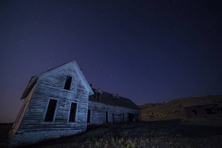 photo of white painted wooden house during nighttime thumbnail