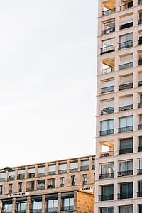 brown concrete building under white cloud blue skies thumbnail