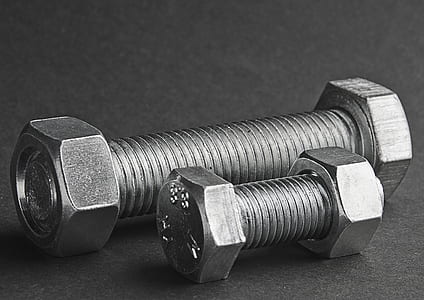 two gray steel bolts and nuts on black surface thumbnail