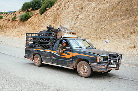 black and orange pickup truck on road thumbnail