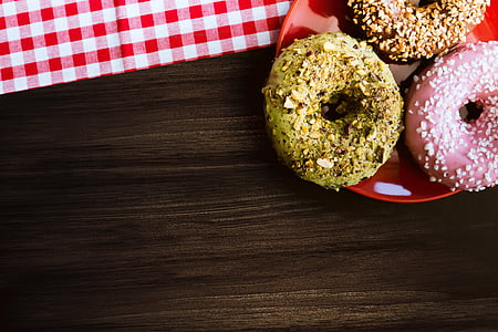 three donuts on red plate thumbnail