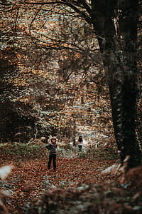 boy standing on brown grass thumbnail
