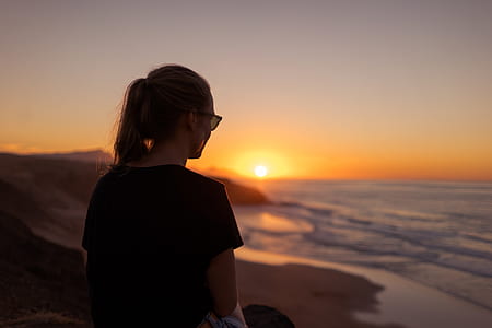 woman looking on beach at sunrise thumbnail