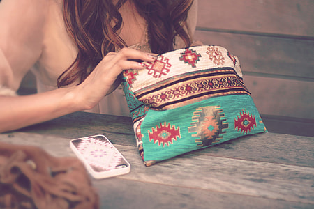 woman holding multi colored textile thumbnail