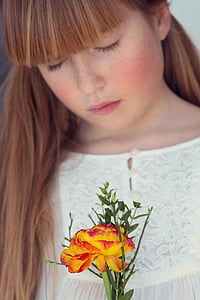 woman holding yellow flower thumbnail