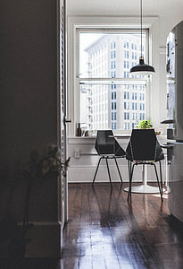 black pendant lamp over table and two chairs near window thumbnail