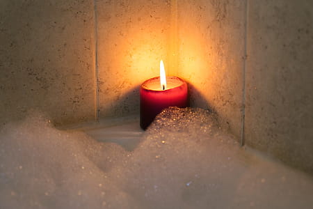 Candle Burning By Bubble Bath Photo thumbnail