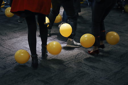 people standing on floors with yellow balloons thumbnail