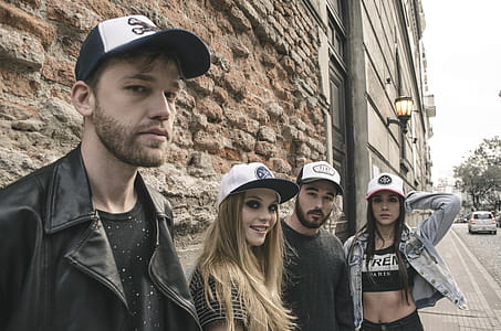 Group of People Wearing Fitted Caps Beside Road thumbnail